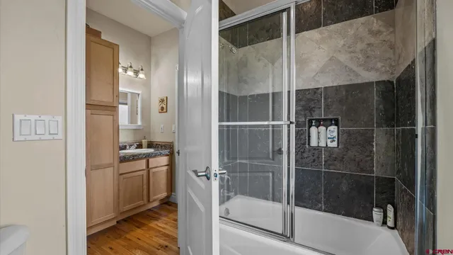 a bathroom with a shower and a sink