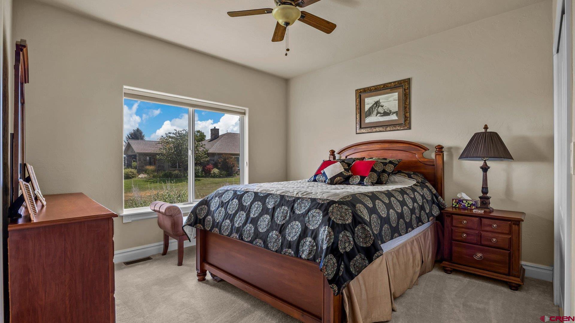 18222 6300th Road Montrose, CO 81403 - Photo 22 of 45 a bedroom with a bed and a chandelier