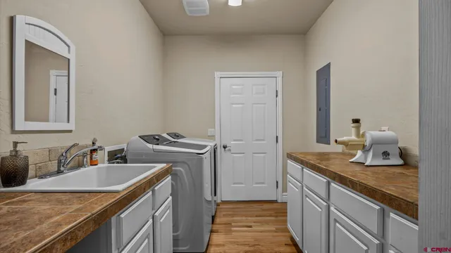 a kitchen with a granite countertop sink a stove and a refrigerator