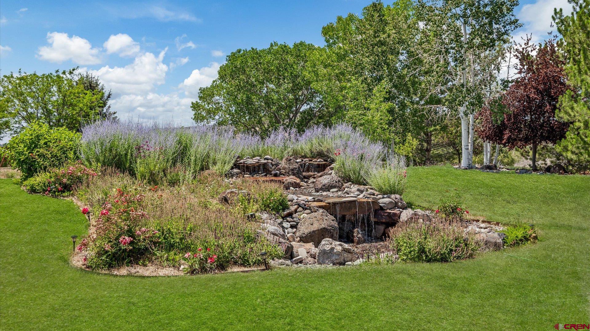 18222 6300th Road Montrose, CO 81403 - Photo 26 of 45 a garden with lots of trees and flowers