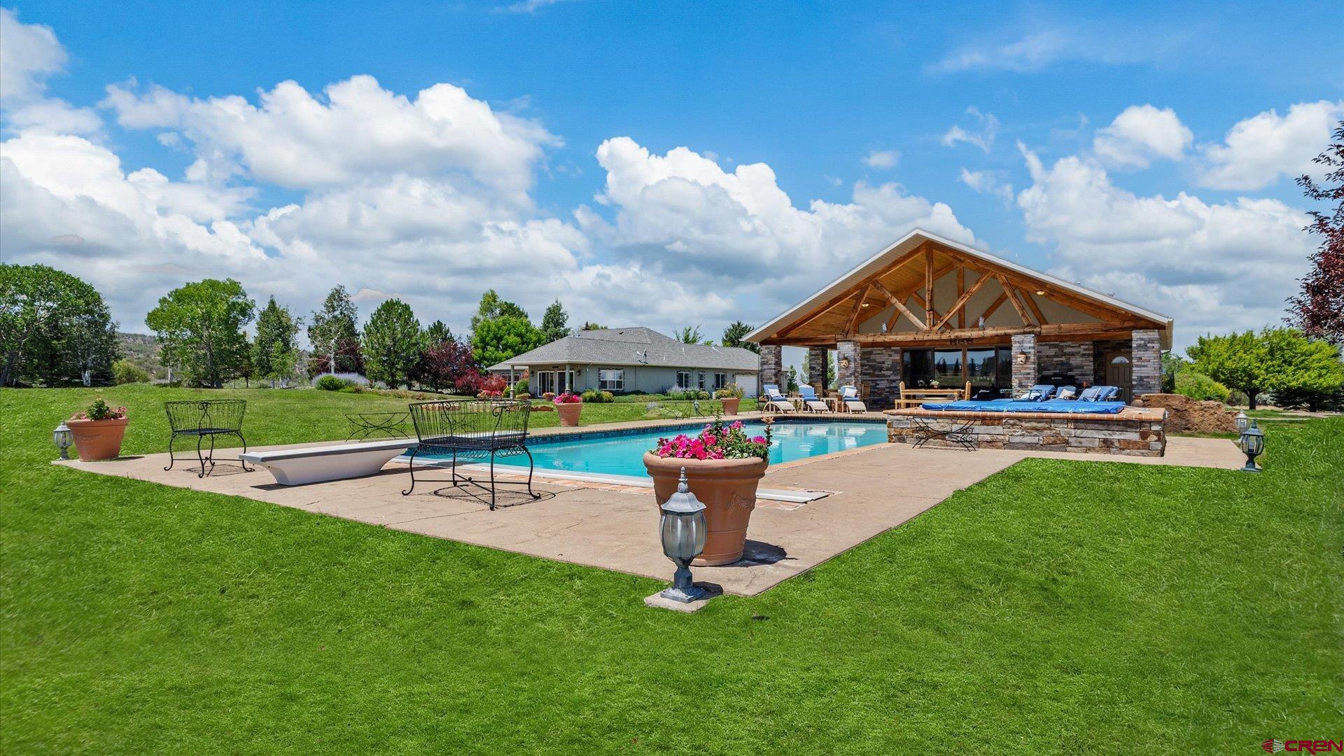 18222 6300th Road Montrose, CO 81403 - Photo 27 of 45 a swimming pool with outdoor seating and garden