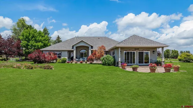 a front view of a house with garden and porch