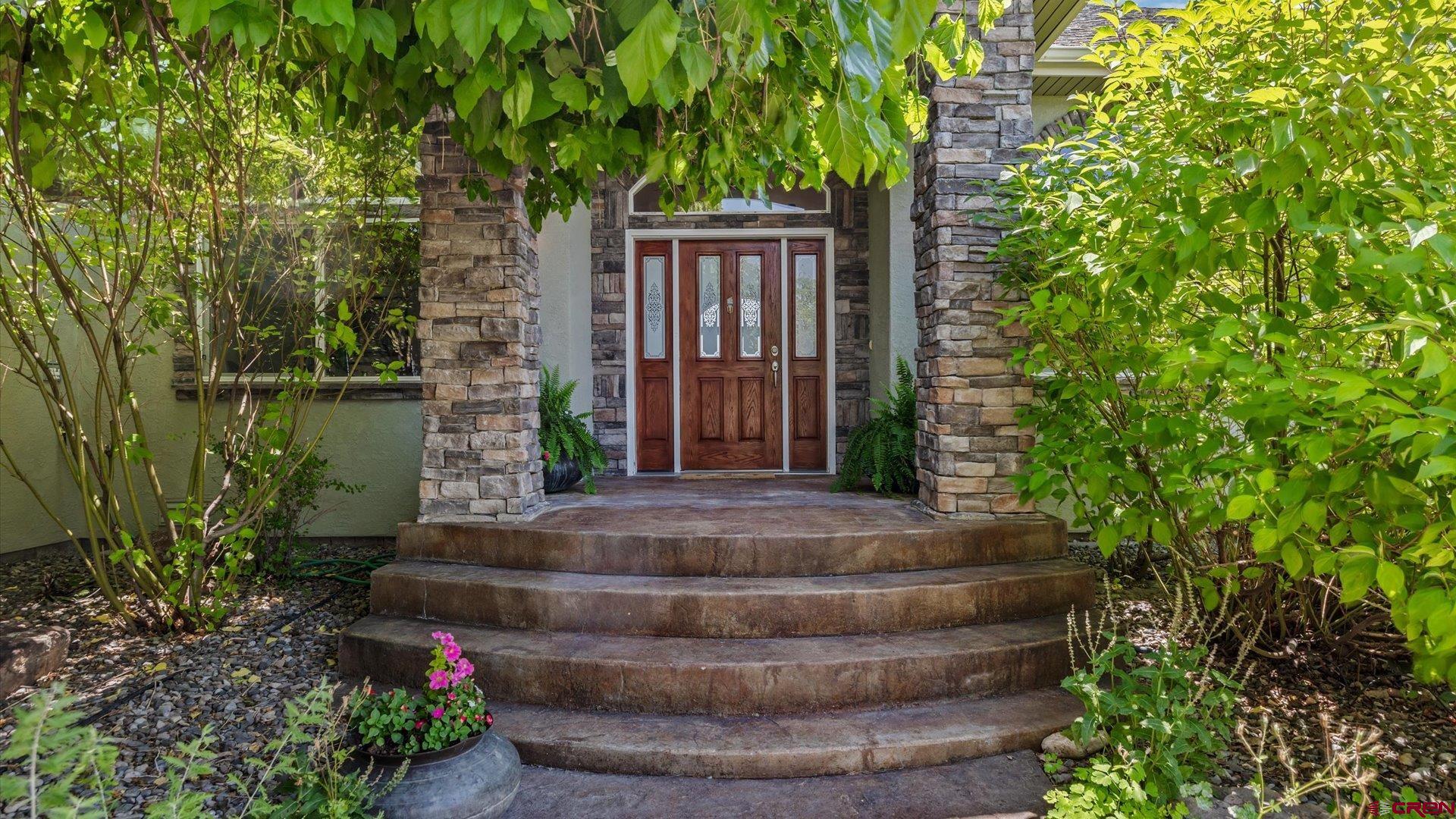 18222 6300th Road Montrose, CO 81403 - Photo 6 of 45 a view of a house with brick walls and flower plants