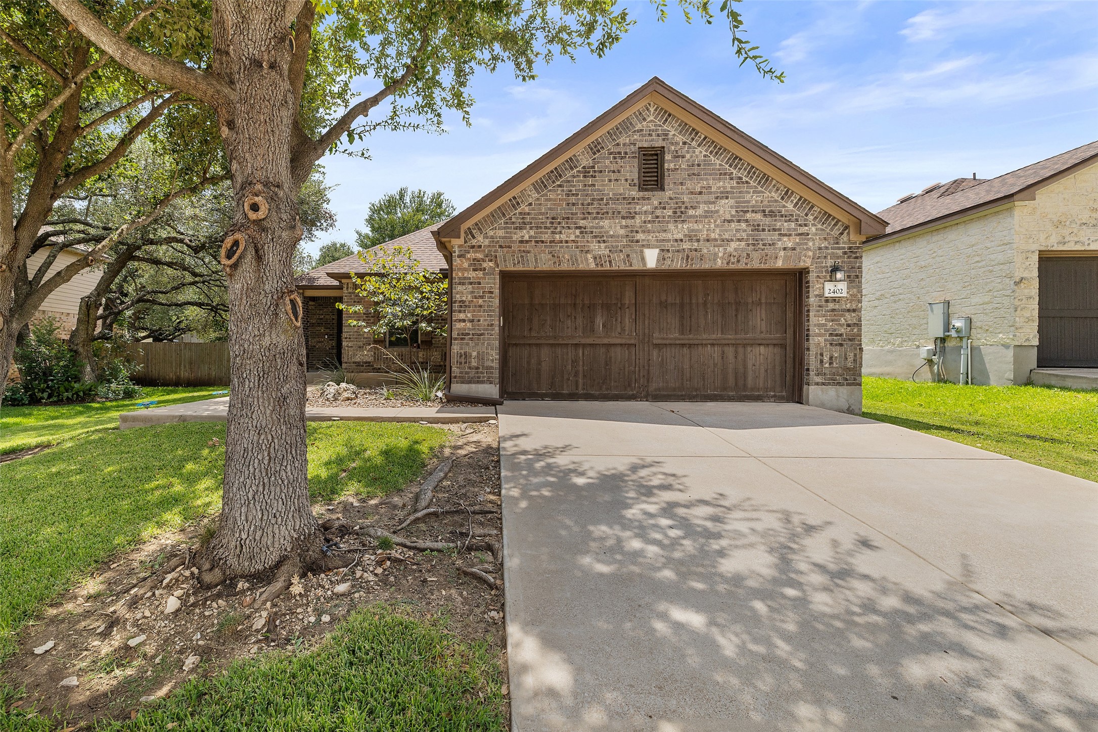 2402 Henry Rifle Road Cedar Park, TX 78613 - Photo 1 of 1 View of front of house featuring brick siding, driveway, and an attached garage