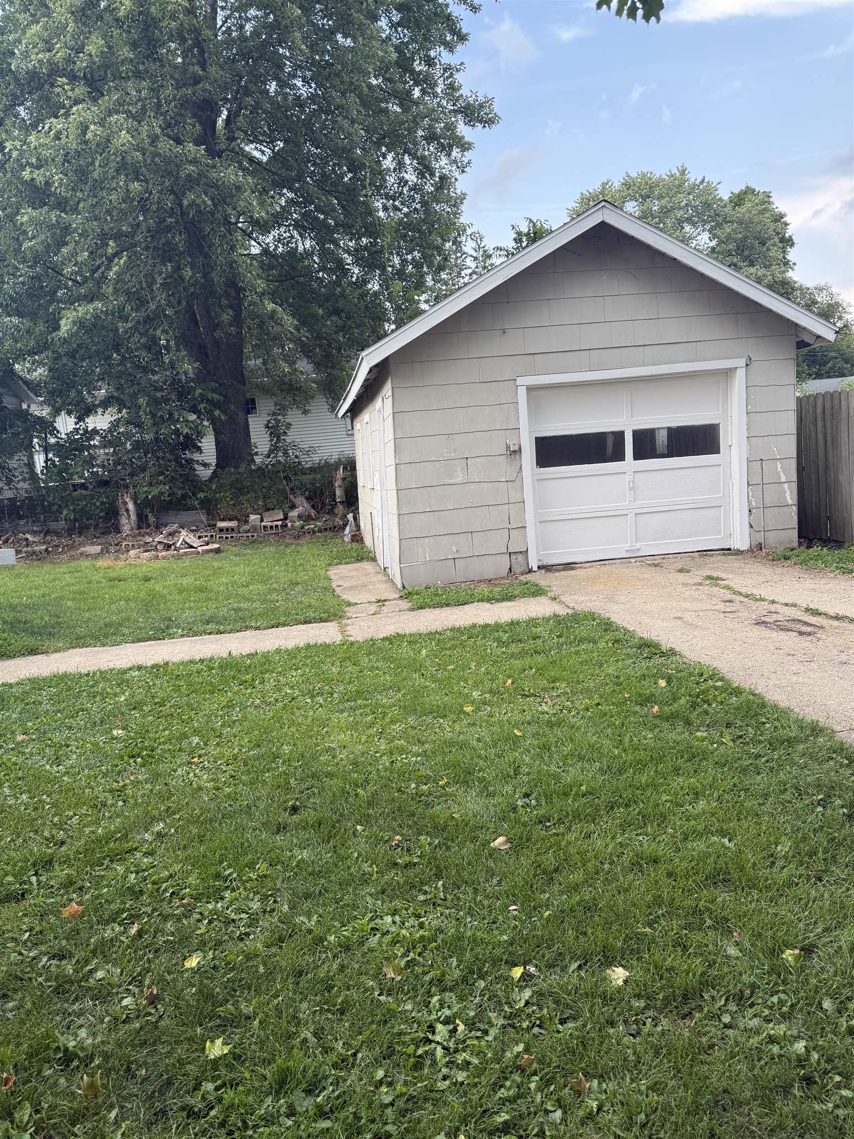 311 East Front Street Byron, IL 61010 - Photo 2 of 15 a white house with green field in front of it