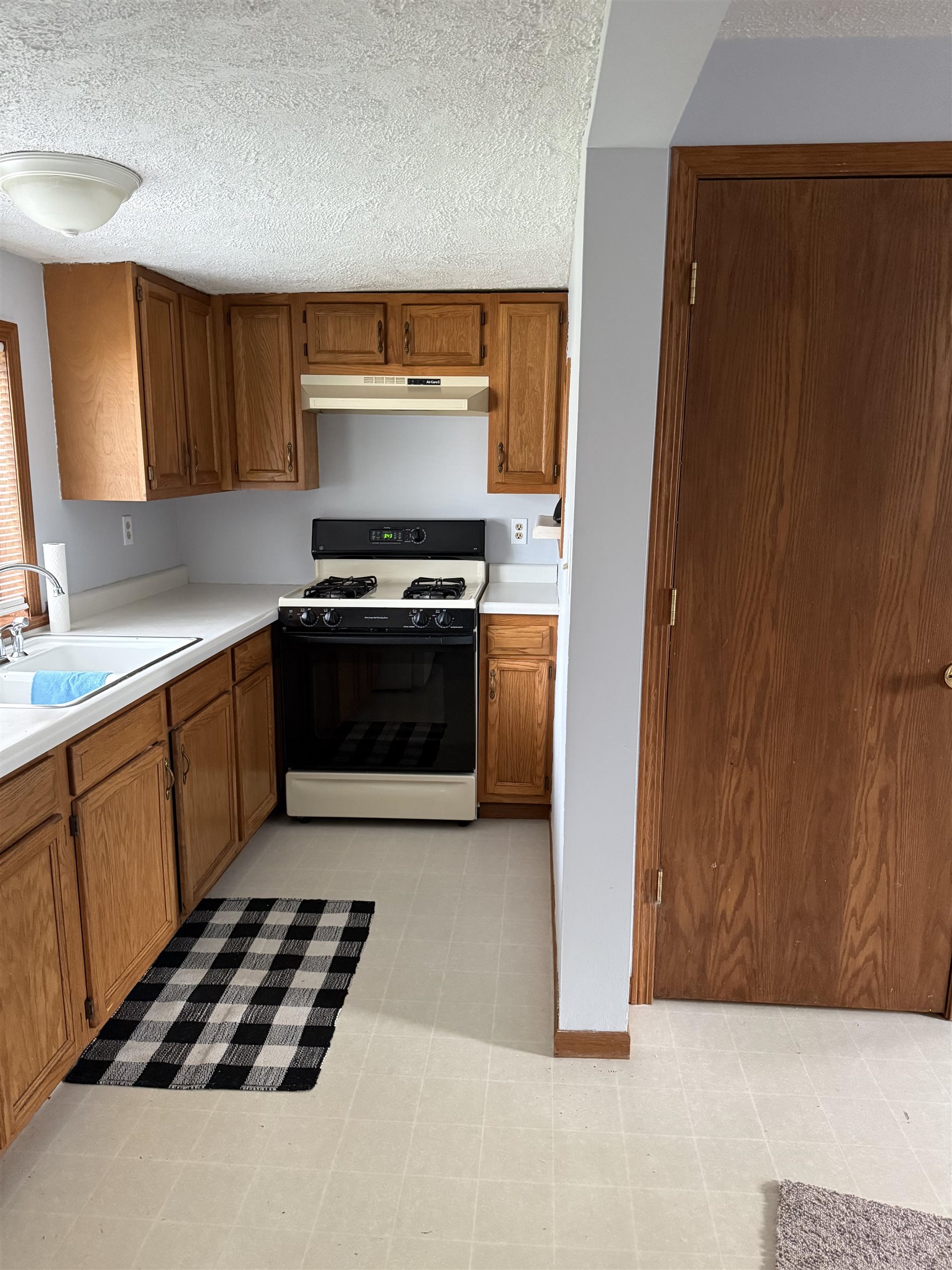 311 East Front Street Byron, IL 61010 - Photo 7 of 15 a kitchen with a stove and a microwave