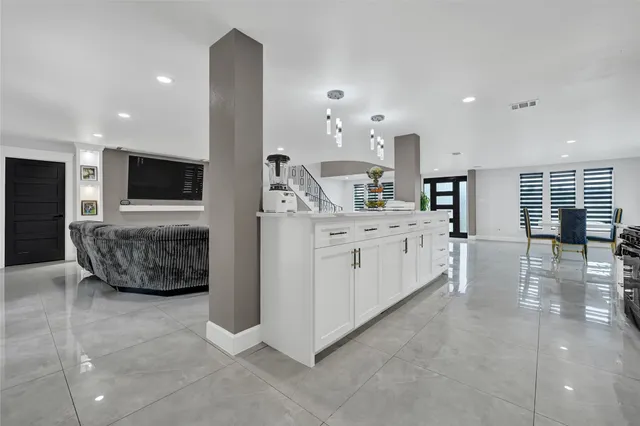 a living room with a fireplace and a walk in closet