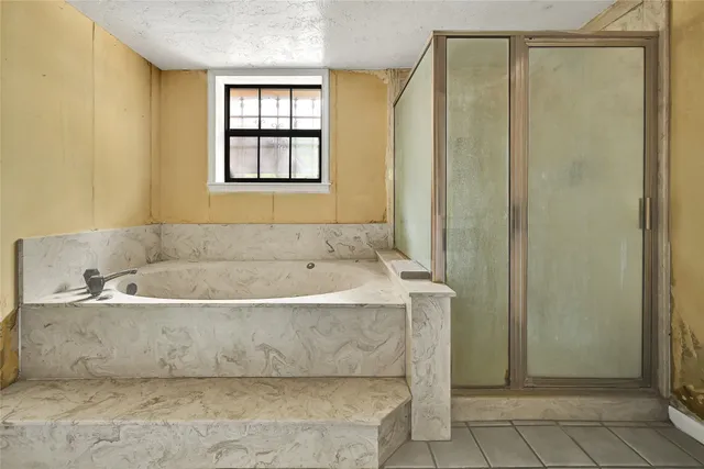 a bathroom with a bathtub and a shower