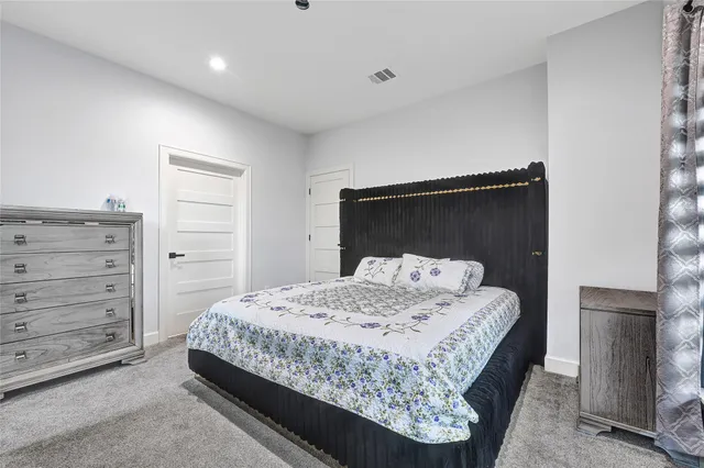 a bedroom with a bed and a dresser