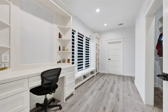 a view of a hallway with painting on the wall