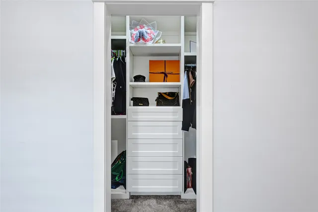 a spacious bathroom with a toilet a sink a mirror and a window