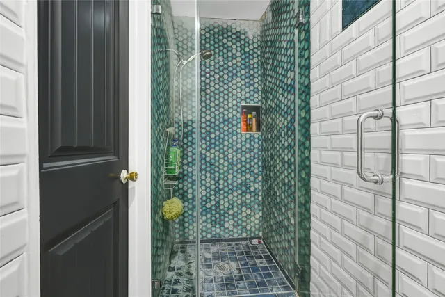 a view of empty room with wooden floor and windows