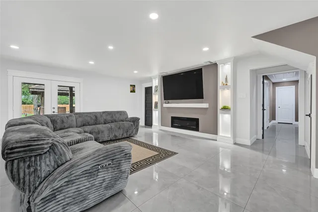 a living room with furniture a fireplace and a flat screen tv