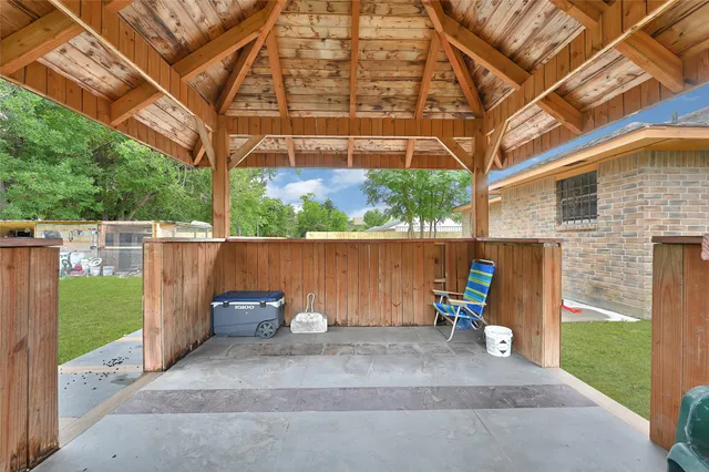 a front view of a house with a garden and trees