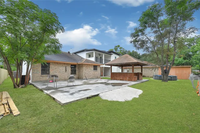 a view of a backyard with sitting area