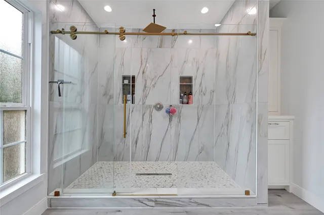 a bathroom with a shower and a tub