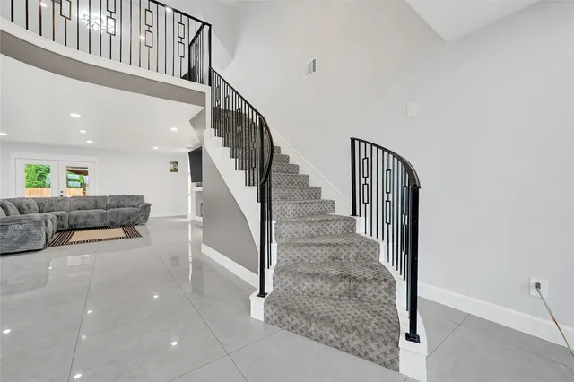 a view of a livingroom with furniture and stairs