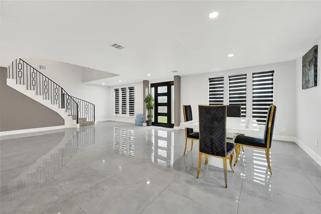 a view of a livingroom with furniture and staircase