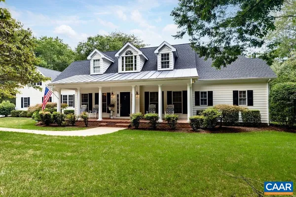 a front view of a house with a yard and porch