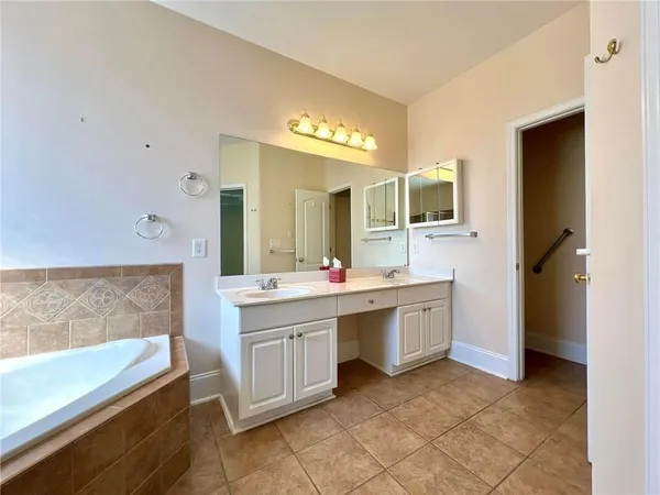 a spacious bathroom with a granite countertop sink and a mirror