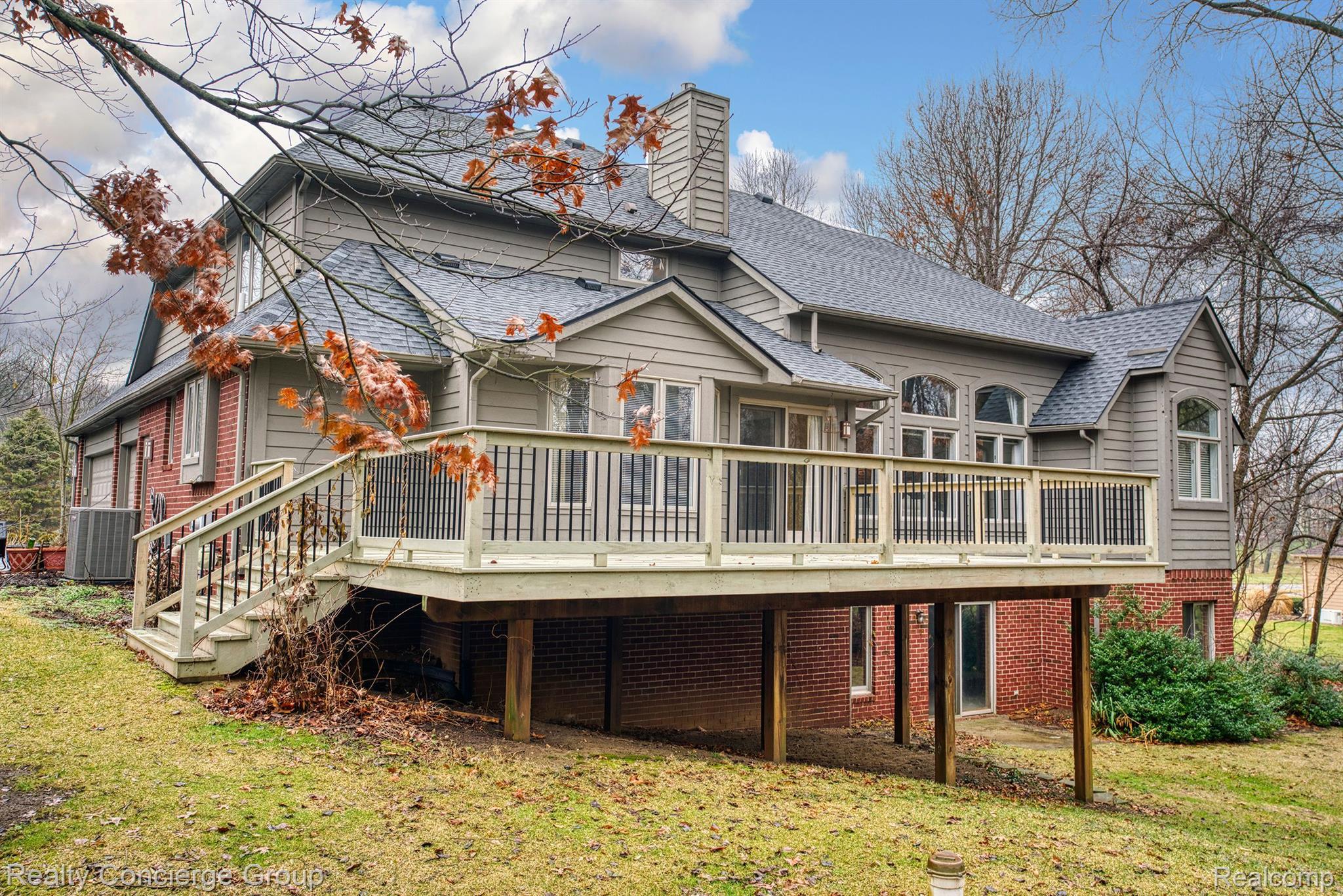 9514 Quail Ridge Run Brighton, MI 48114 - Photo 34 of 37 Deck wraps around back & offers stairs to backyard