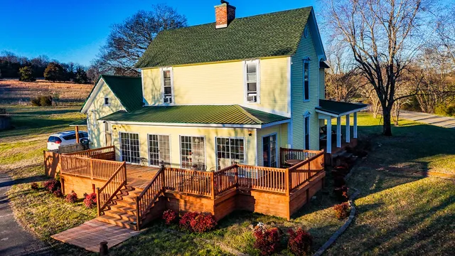 an aerial view of a house with swimming pool and sitting area