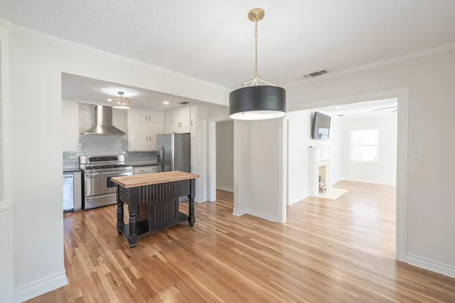 a en suite bathroom with a granite countertop sink and a mirror