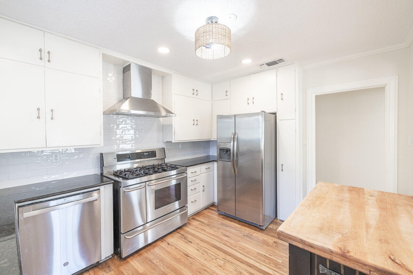 2810 24th Street Lubbock, TX 79410 - Photo 14 of 47 a kitchen with stainless steel appliances granite countertop a stove a refrigerator and a refrigerator
