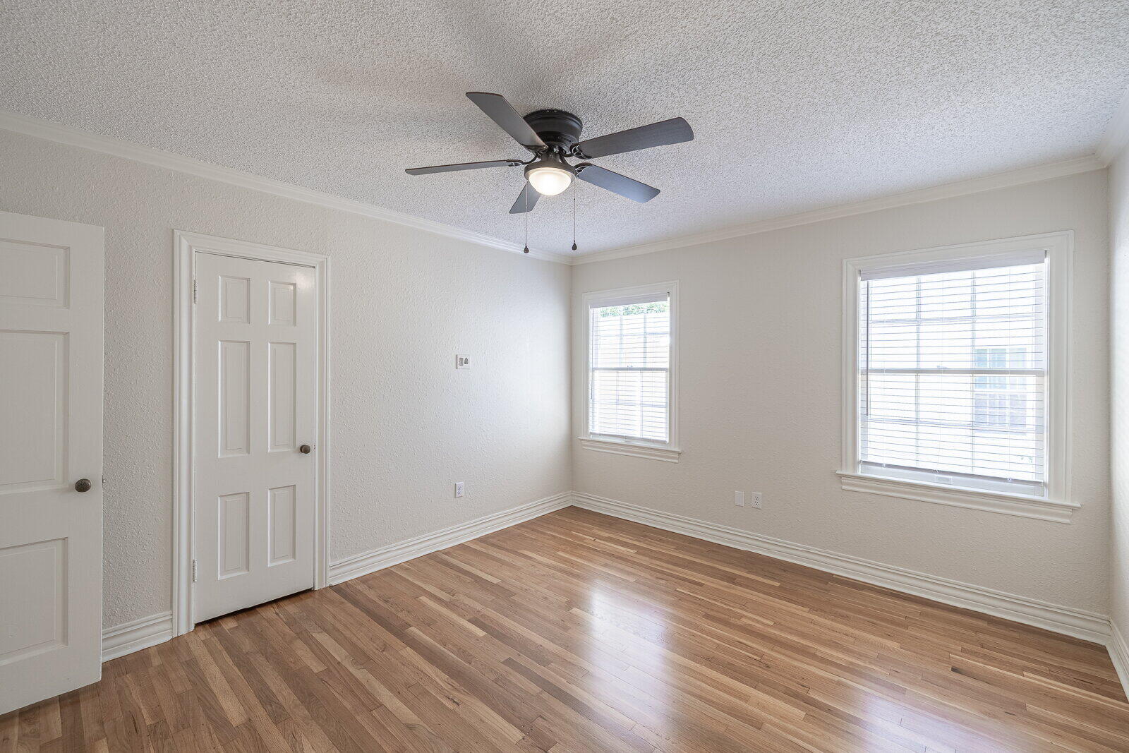 2810 24th Street Lubbock, TX 79410 - Photo 21 of 47 a view of an empty room with wooden floor and a window