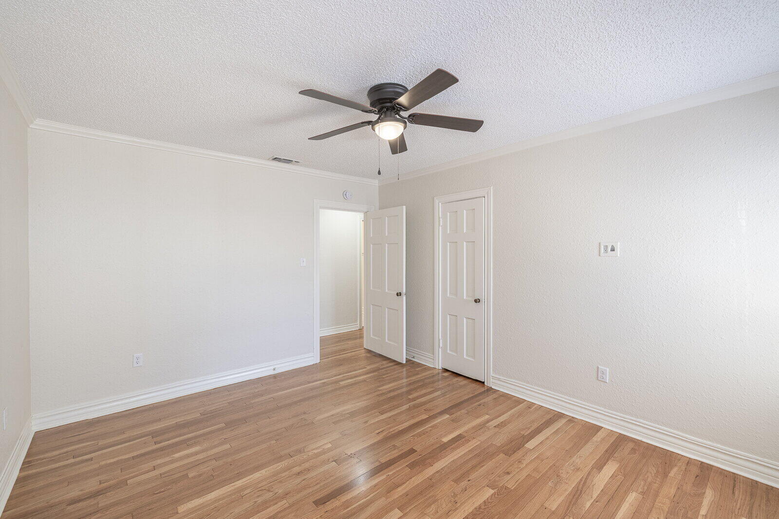 2810 24th Street Lubbock, TX 79410 - Photo 22 of 47 a view of a room with wooden floor and a ceiling fan