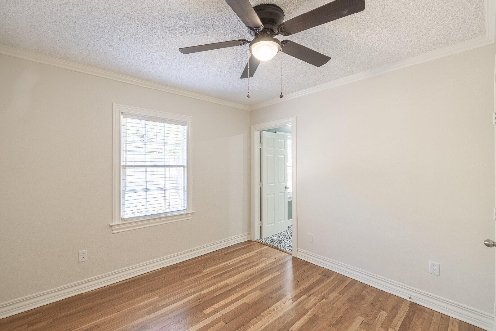 2810 24th Street Lubbock, TX 79410 - Photo 31 of 47 an empty room with wooden floor fan and windows