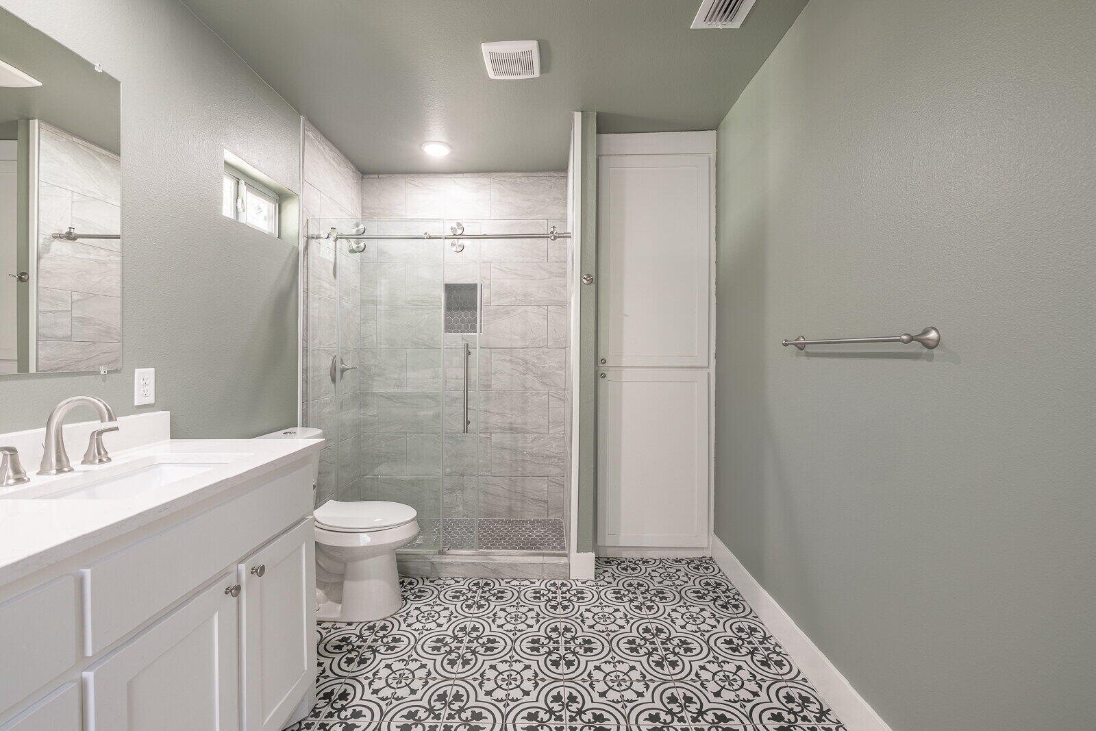 2810 24th Street Lubbock, TX 79410 - Photo 36 of 47 a bathroom with a sink a toilet a shower and a mirror