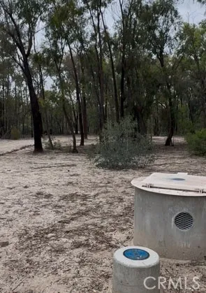 a backyard of a house with fountain table and chairs