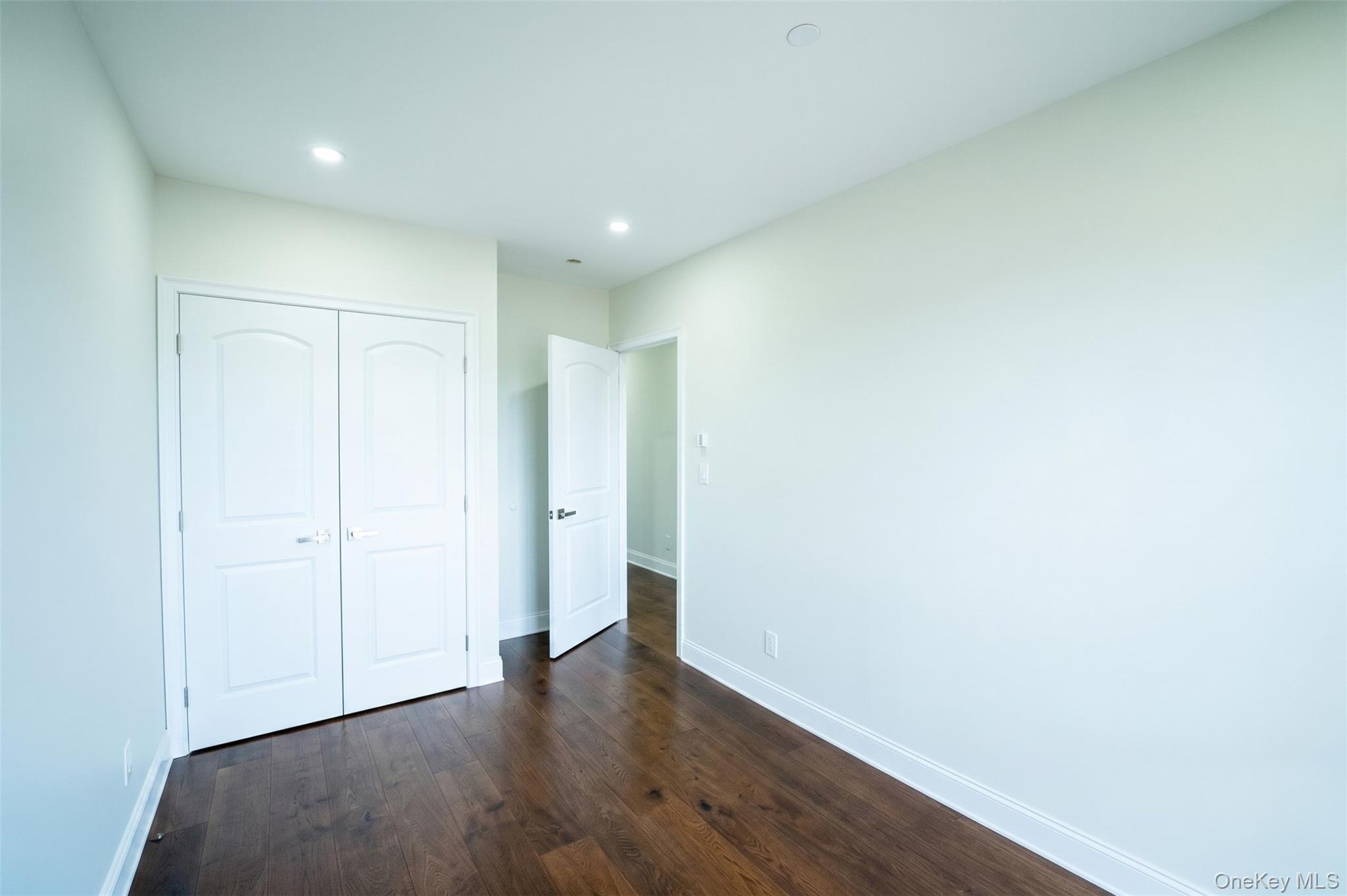 150-26 12th Road Queens, NY 11357 - Photo 15 of 17 a view of an empty room with wooden floor
