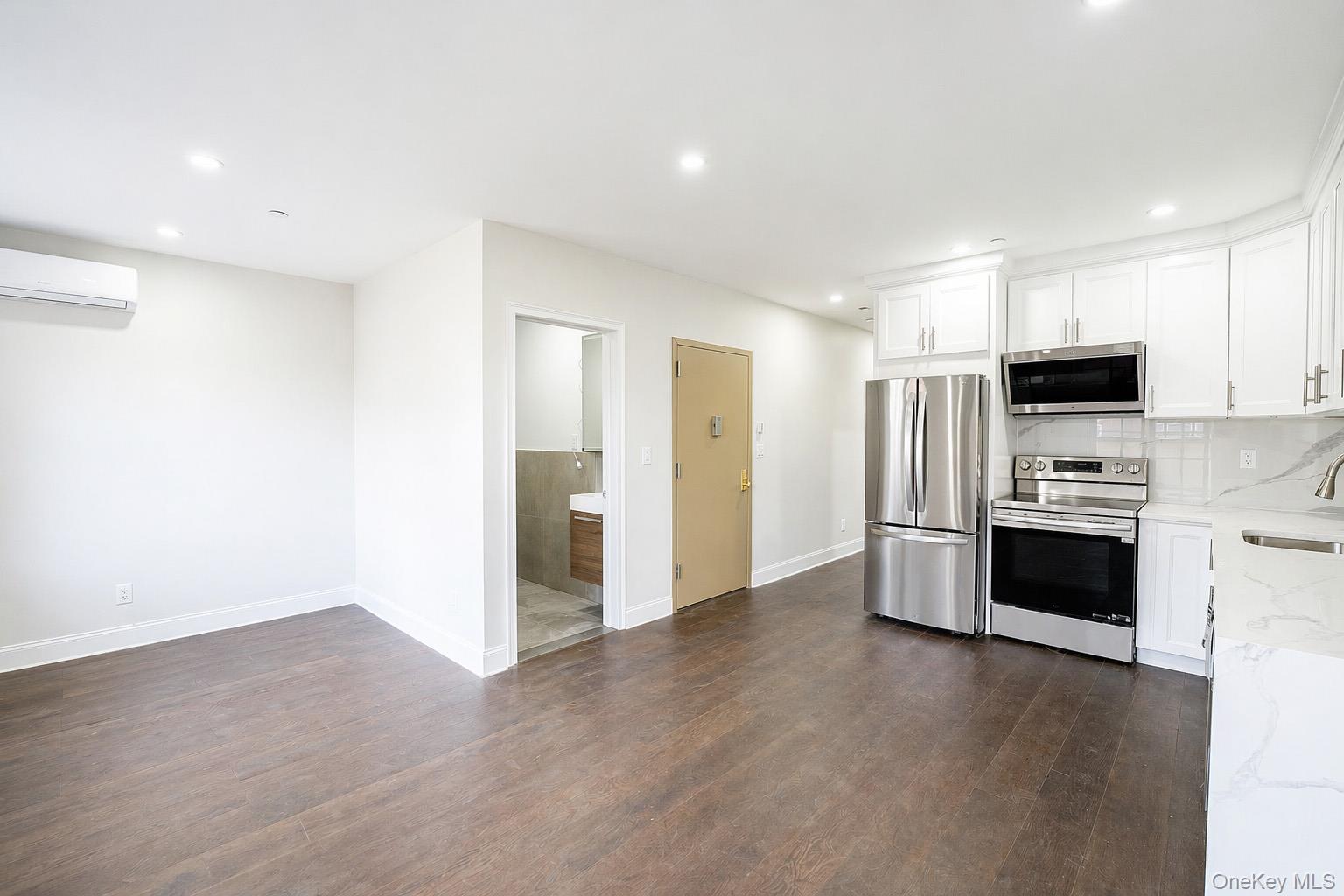 150-26 12th Road Queens, NY 11357 - Photo 5 of 17 a kitchen with stainless steel appliances a refrigerator and a stove top oven