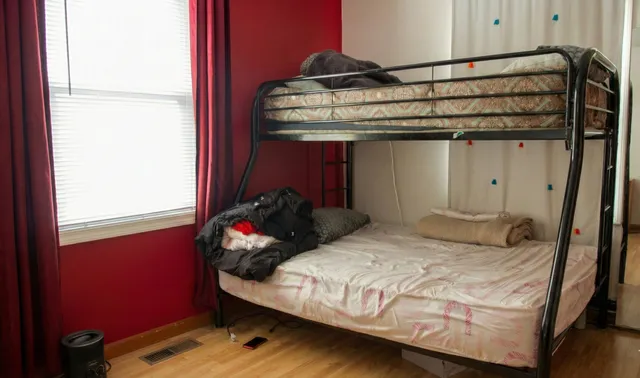 a bedroom with a bed and window