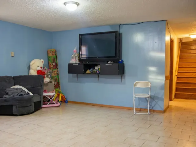 a view of a room with furniture and a window