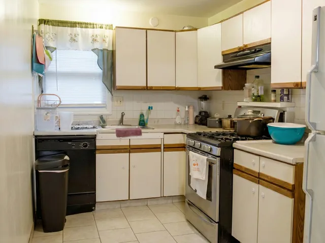 a bathroom with a sink toilet and window