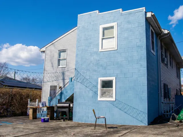 a brick building with a street sign on the side of it
