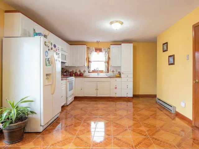 a kitchen with stainless steel appliances a refrigerator a sink a stove a window