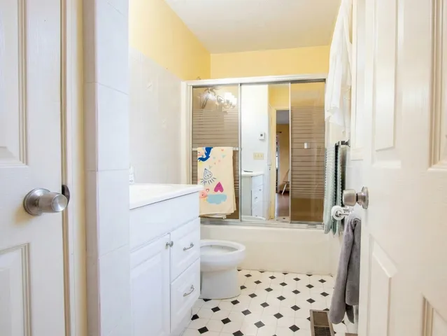 a bathroom with a sink a toilet and shower curtain