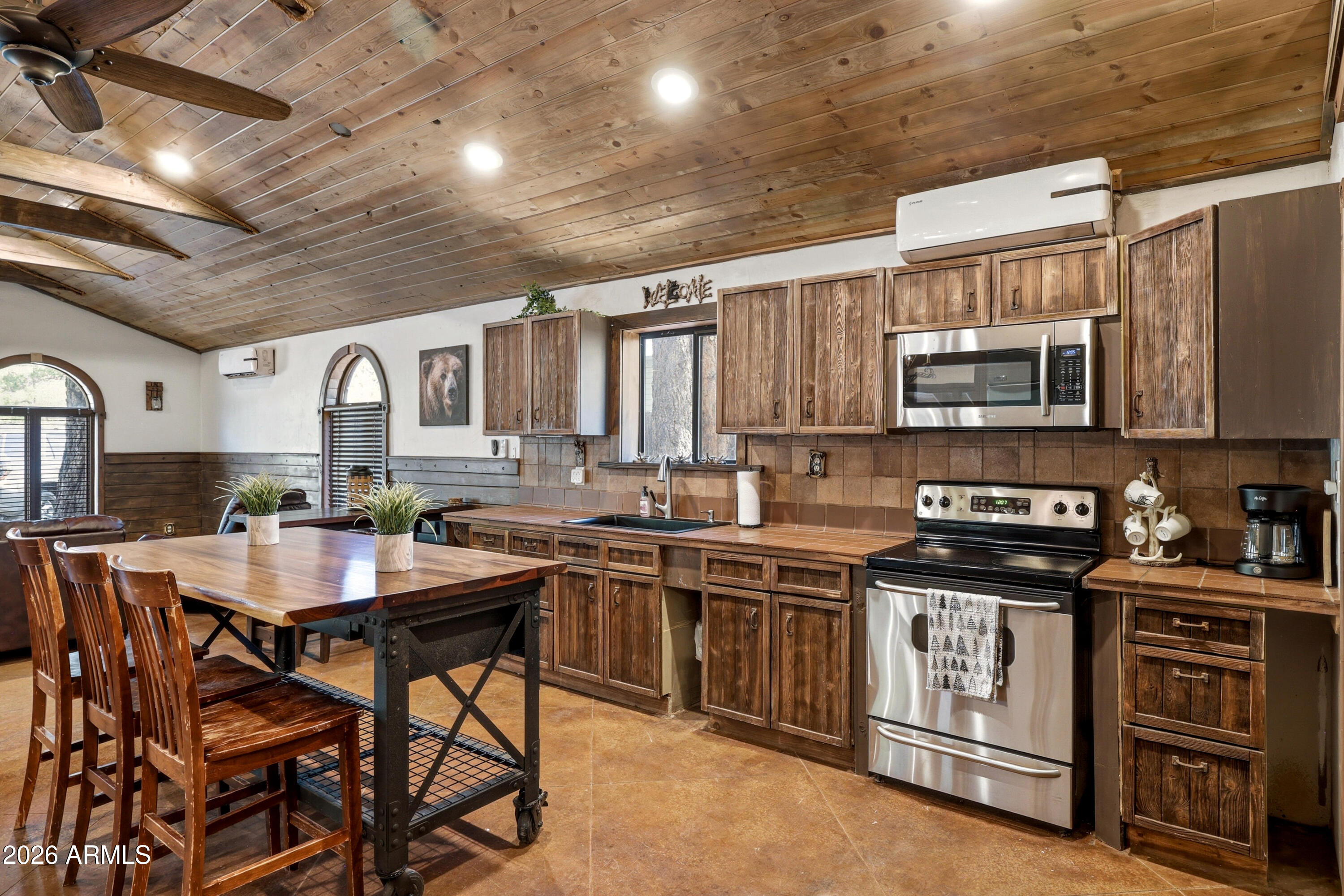 4971 Buck Springs Road Pinetop, AZ 85935 - Photo 9 of 32 a kitchen with stainless steel appliances granite countertop a stove top oven a sink dishwasher and cabinets
