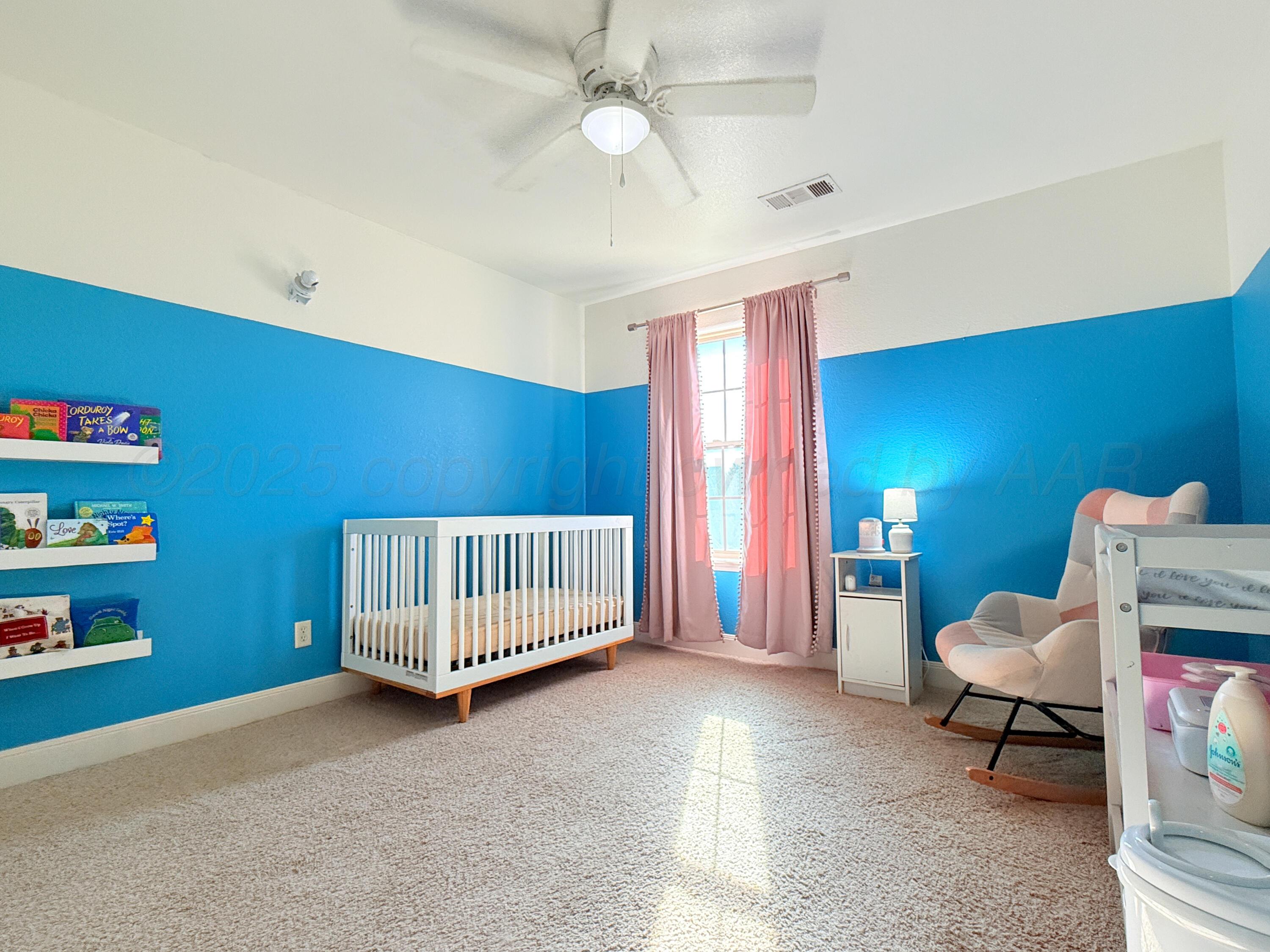 3701 Arden Road Amarillo, TX 79118 - Photo 12 of 18 a living room with furniture and a baby crib