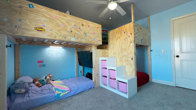 a bedroom with bed and a chandelier