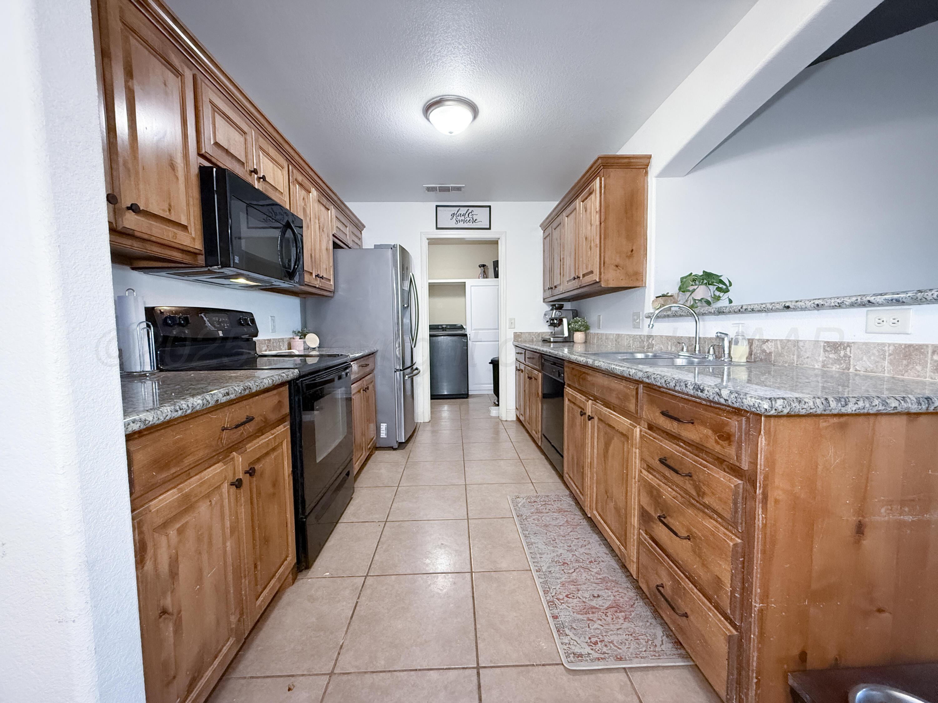 3701 Arden Road Amarillo, TX 79118 - Photo 8 of 18 a kitchen with stainless steel appliances granite countertop a stove a sink and a microwave