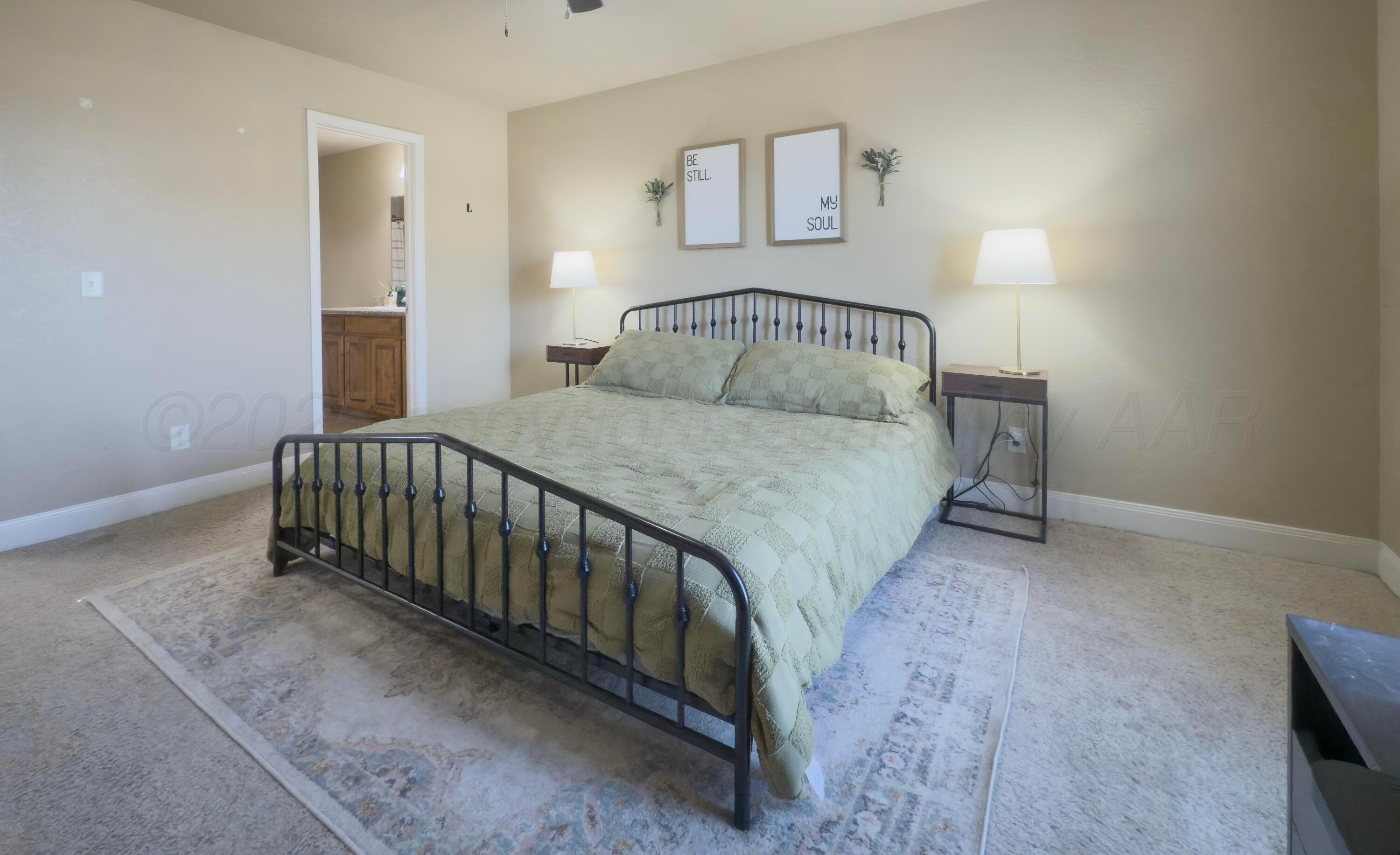 3701 Arden Road Amarillo, TX 79118 - Photo 10 of 18 a bedroom with a bed and a night stand