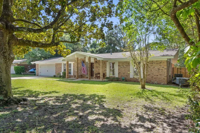 a living room with furniture wooden floor and a flat screen tv