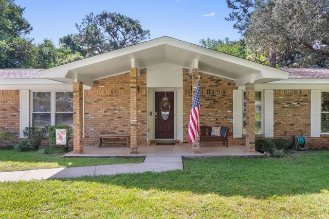 a bedroom with a bed and a tv on a dresser