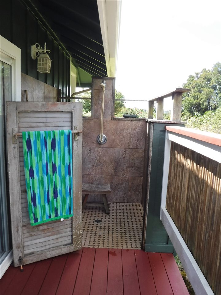 1209 West Kuiaha Road, Unit 2 Haiku, HI 96708 - Photo 19 of 30 a view of a balcony with wooden floor and fence