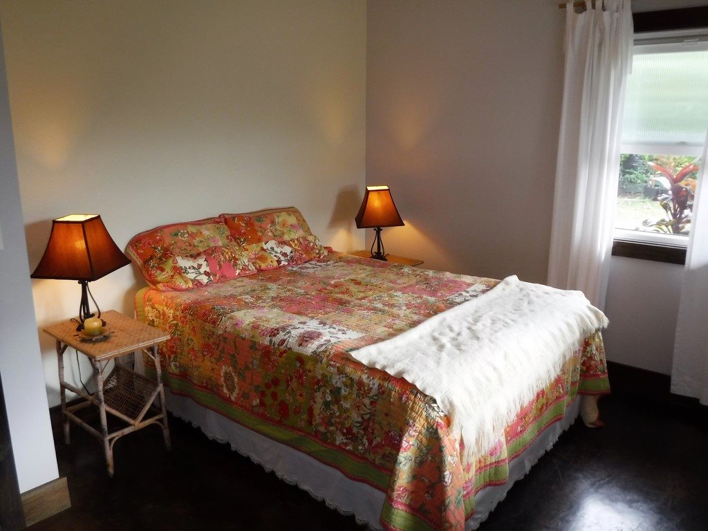 1209 West Kuiaha Road, Unit 2 Haiku, HI 96708 - Photo 21 of 30 a bedroom with a bed and dresser next to a window